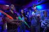 Utkarsh Ambudkar, Sonequa Martin-Green (middle) and ‘My Dead Friend Zoe’ director/co-writer Kyle Hausmann-Stokes prepare for a scene in which the 2 actors play a shooter arcade game. 