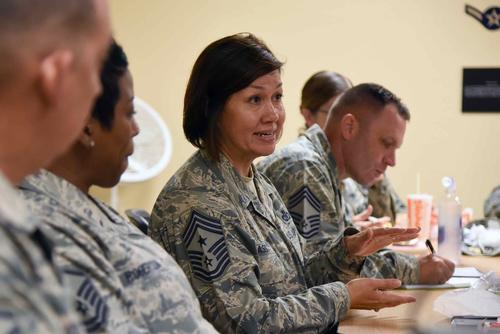 Chief Master Sgt. JoAnne Bass engages in conversation with Airmen at the Keesler Professional Development Center.