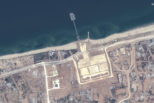 overview of the new pier off Gaza and aid trucks
