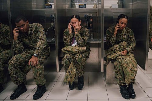 Navy recruits call home during their scheduled divisional phone calls at Recruit Training Command