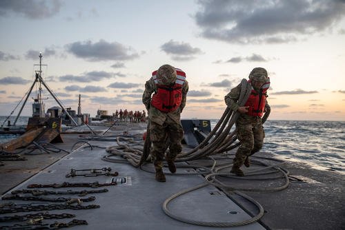 Soldiers transport the Trident Pier across the Mediterranean Sea