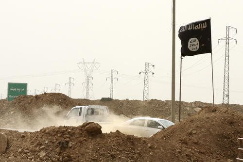 Islamic State militants pass a checkpoint in the village of Maryam Begg in Kirkuk