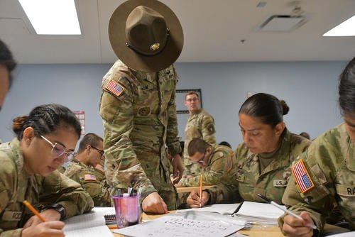 A drill sergeant assists trainees at the Future Soldier Preparatory Course with their General Testing studies