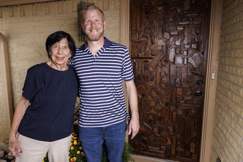 Bonnye Sherman with Jeremiah Dee outside her home in front of the front door he restored for her.