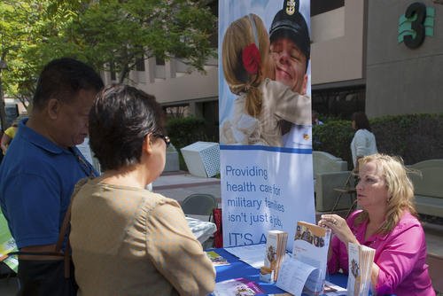 A Tricare representative gives information about the program to guests at the second annual Exceptional Family Member Program Fair at Naval Medical Center San Diego.