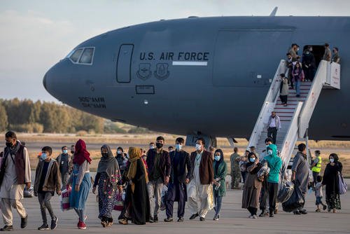 Afghan evacuees disembark from a U.S. Air Force plane at Rota Naval Base