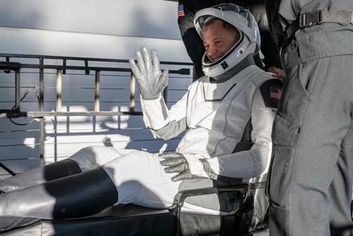 NASA astronaut Col. Nick Hague is helped out of a SpaceX Dragon spacecraft