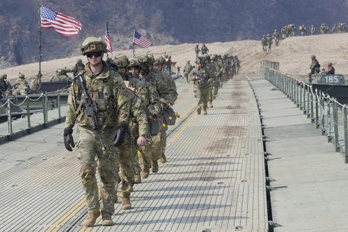 U.S. Army soldiers cross a floating bridge on the Imjin River
