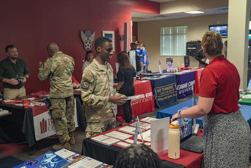 Representatives from colleges and universities present information at education fair