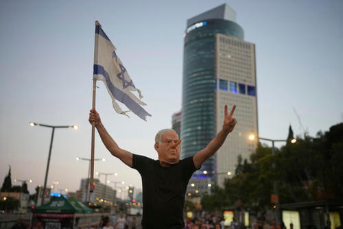 A demonstrator takes part in a performance during a protest.