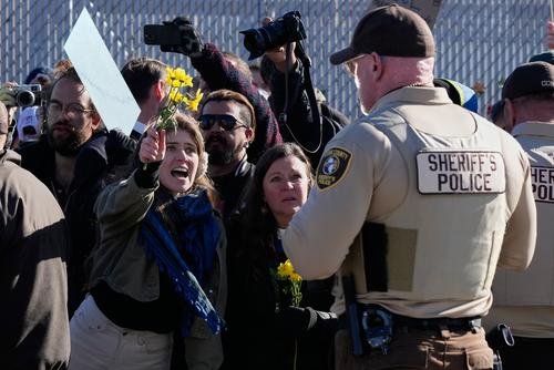 Protesters gather outside an ICE processing facility in Broadview, Ill, a suburb of Chicago, Friday, Oct. 24, 2025. (AP Photo/Nam Y. Huh)