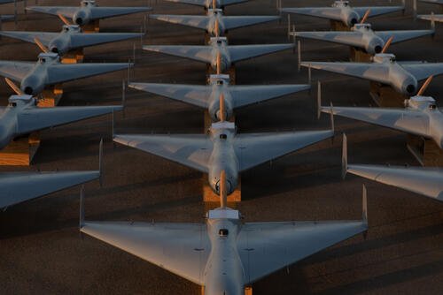 Low-cost Unmanned Combat Attack System (LUCAS) drones are positioned on the tarmac at a base in the U.S. Central Command (CENTCOM) operating area, Nov. 23. (U.S. Central Command Public Affairs)