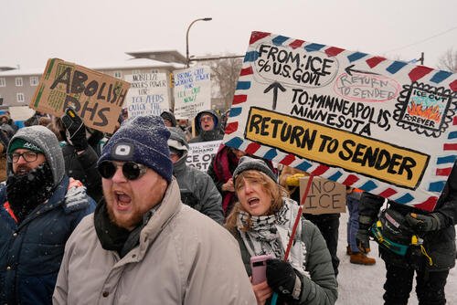 People protest near a post office in Minneapolis.