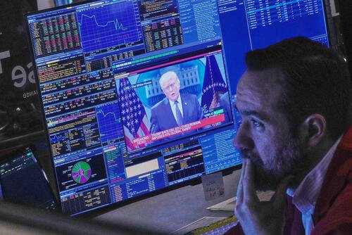 President Donald Trump appears on trader Robert Greason's screen on the floor of the New York Stock Exchange, Friday, Feb. 20, 2026. (AP Photo/Richard Drew)