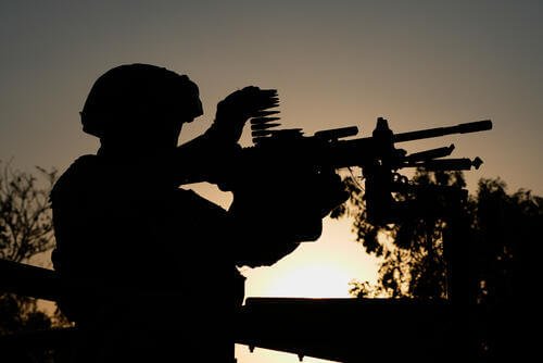 National Guards patrol the area outside the morgue where the bodies of fellow guardsmen killed in attacks lie in Guadalajara, Mexico, Tuesday, Feb. 24, 2026, two days after the Mexican army killed Jalisco New Generation Cartel leader Nemesio Oseguera Cervantes, known as "El Mencho." (AP Photo/Marco Ugarte)