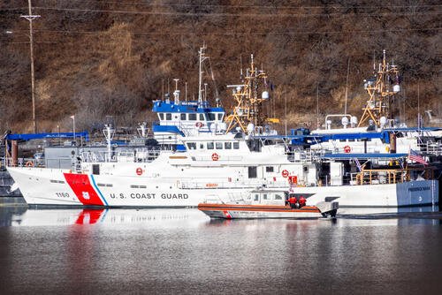 A U.S. Coast Guard 36-foot Special Purpose Craft-Training (SPC-T) boat maneuvers in front of the USCG Cutter Fredrick Mann (WPC1160) in Women's Bay during ARCTIC EDGE 2026 (AE26) at U.S. Coast Guard Air Station Kodiak in Kodiak, Alaska, Feb. 27, 2026. (U.S. Marine Corps photo by Lance Cpl. Thirteen Bahizi)