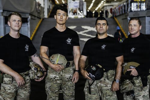 From left, Hospital Corpsman 1st Class Steve Kapala, Lt. Cmdr. Jesse Wang, Chief Hospital Corpsman Vlad Link, and Senior Chief Hospital Corspman Laddy Aldridge, the U.S. Navy dive medical team with Explosive Ordnance Disposal Group 1, pose for a group photo ahead of Artemis II recovery operations while underway on Amphibious transport dock ship USS John P. Murtha (LPD 26) in the Pacific Ocean, April 9, 2026.  (U.S. Navy photo by Mass Communication Specialist 2nd Class August Clawson)